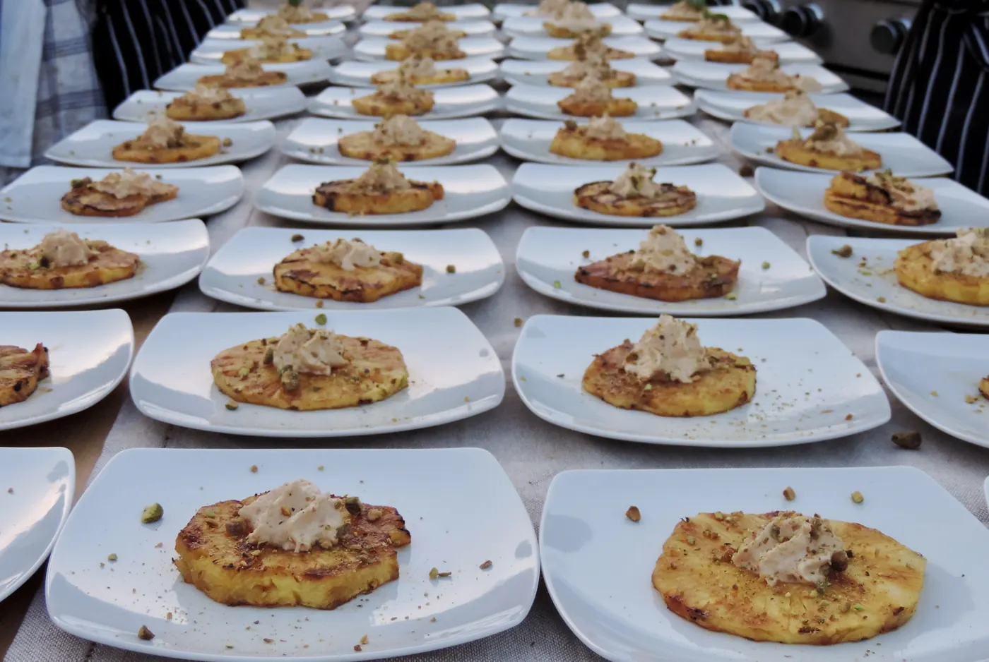 Pineapple brulee plated in rows on the long table