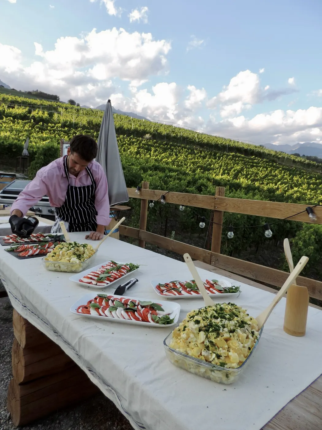 The salads laid out, the vineyard behind