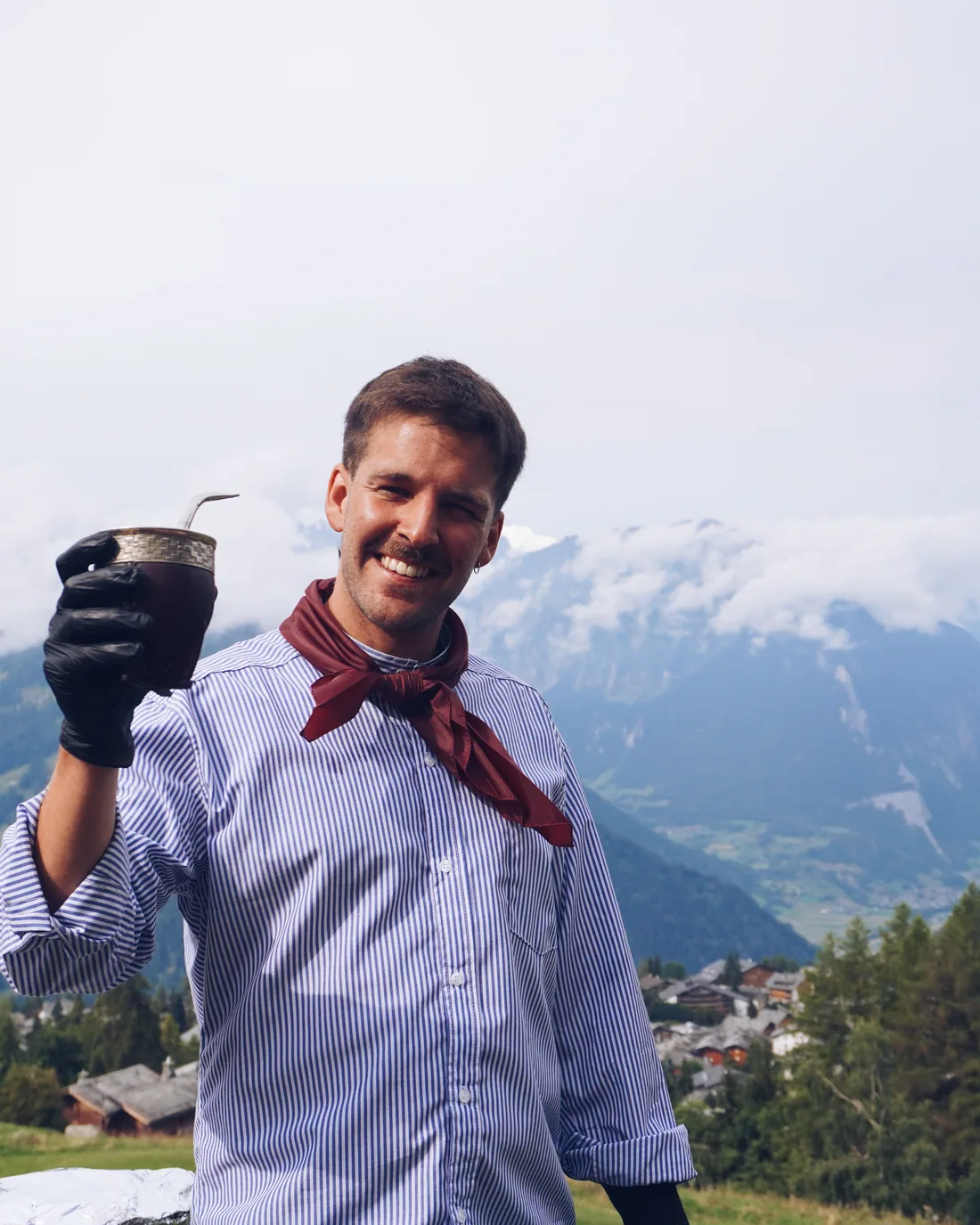 Pancho holding a mate, the valley behind him