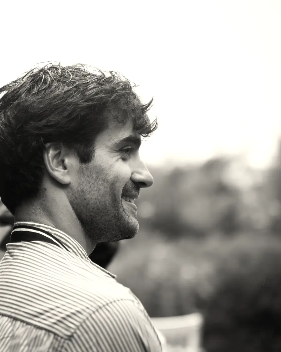 Pablito in profile, smiling, in a striped shirt