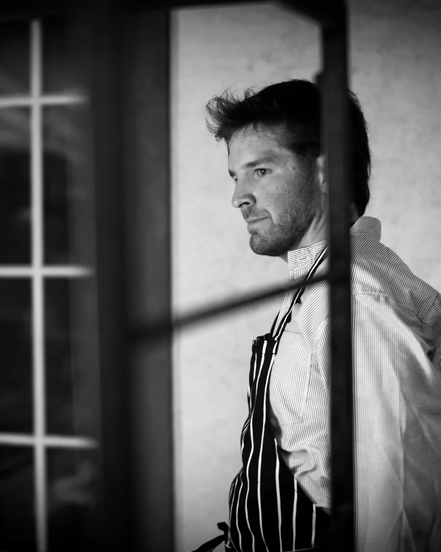 Pancho in profile in the doorway, in his striped apron