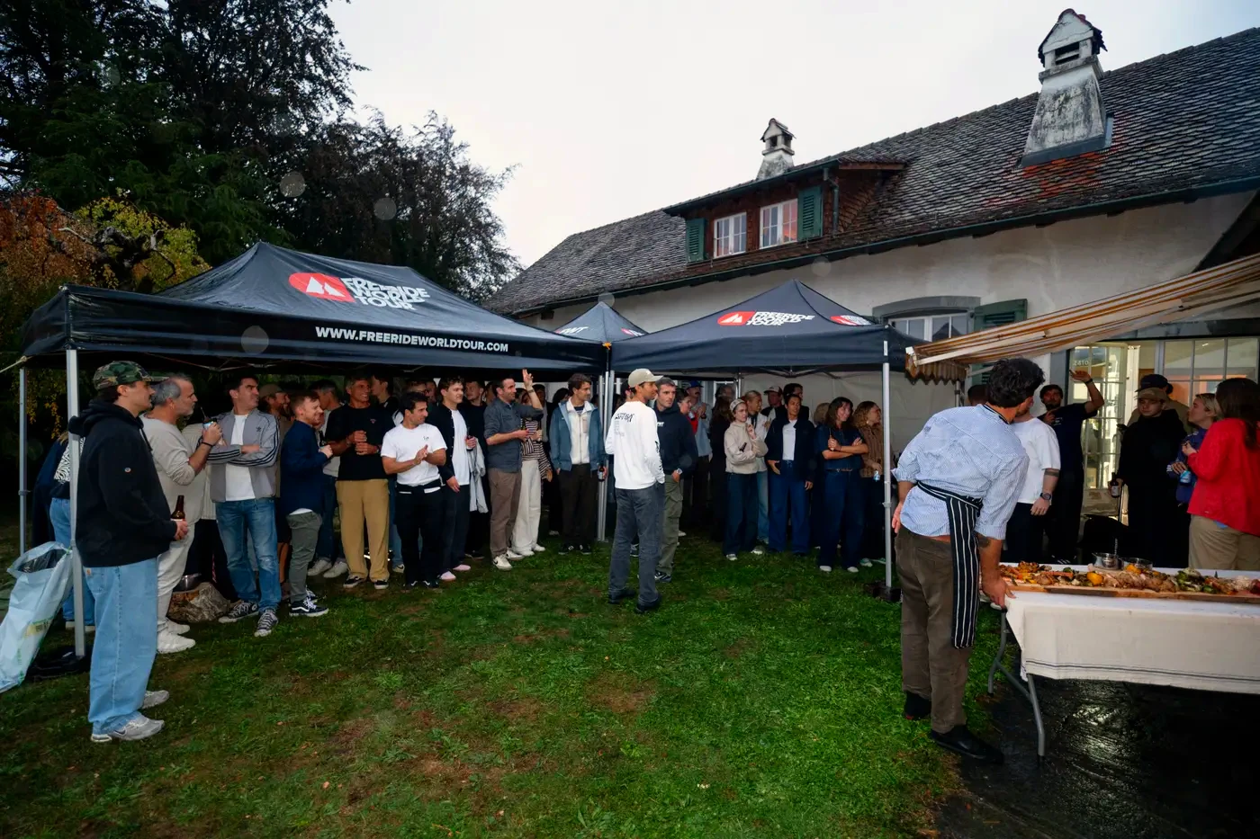 The whole crowd on the lawn, gathered round for the show