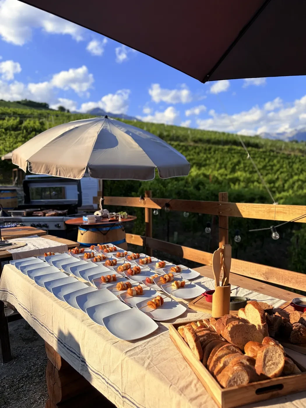 The table set up under two parasols, the sky wide open behind